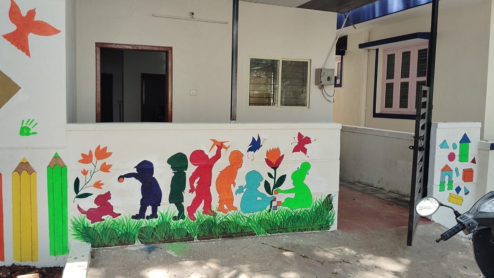 Hand-painted mural of children at Joy of Learning Montessori